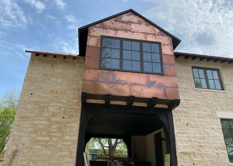 Copper metal panel facade on a stone building for Skylight Installation in Montebello